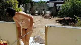Nude housewife cleaning the balcony - 1 image