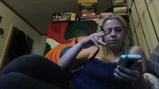Hot blonde smokes clove cigarettes, plays on phone and plays with tits - 2 image