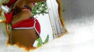 Big-ass Latina waxing her pussy in an outdoor booth - 13 image